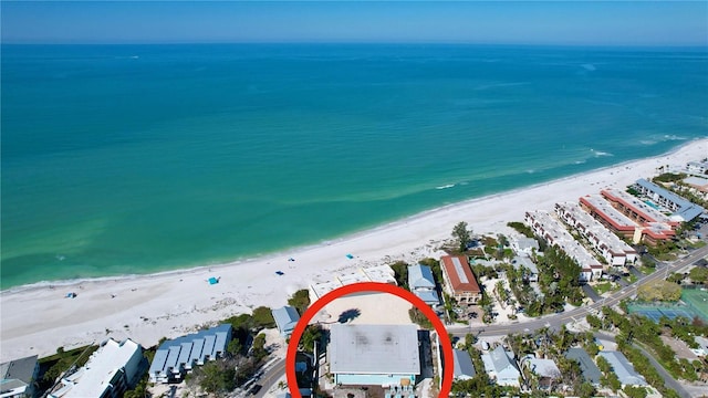 aerial view with a water view and a view of the beach