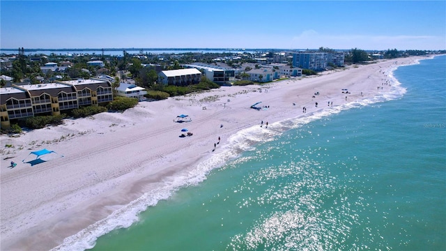 drone / aerial view featuring a water view and a view of the beach