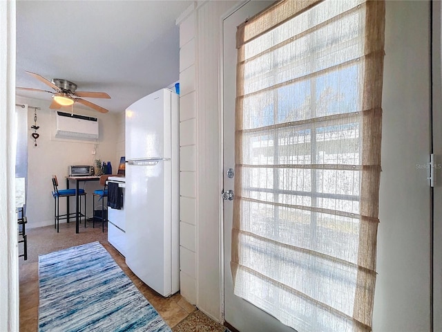 interior space featuring a ceiling fan and a wall mounted AC