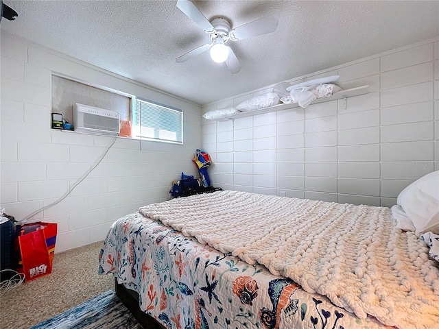 carpeted bedroom with a textured ceiling, concrete block wall, and a ceiling fan