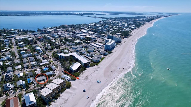 aerial view with a water view and a view of the beach