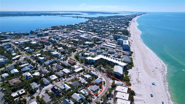 drone / aerial view with a water view and a beach view