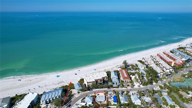 aerial view with a water view and a beach view