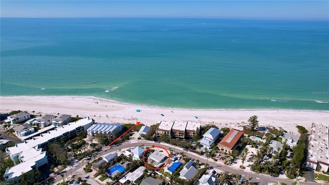 drone / aerial view with a water view and a beach view