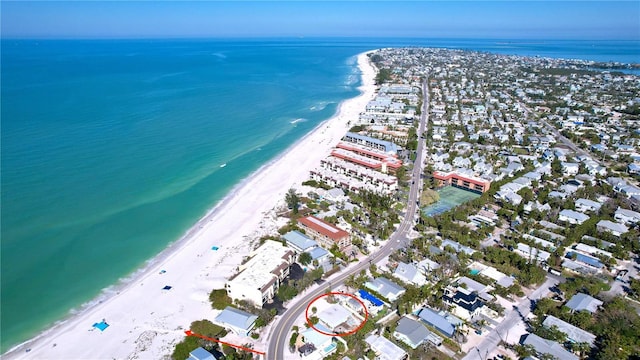 bird's eye view with a water view and a beach view