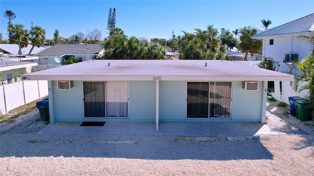 back of property with a patio area and fence