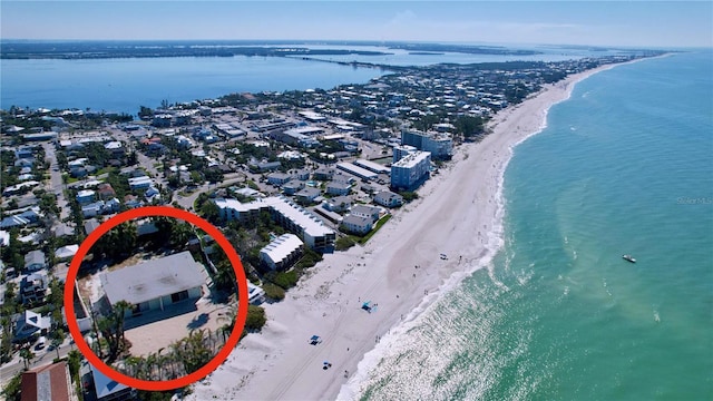 drone / aerial view featuring a water view and a beach view