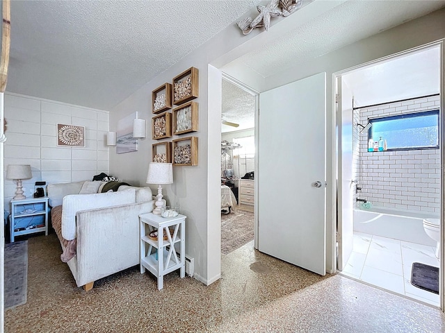 bedroom with a textured ceiling and speckled floor