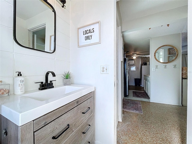 bathroom featuring ceiling fan and vanity