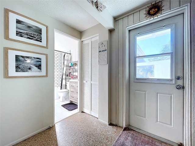 entryway featuring a textured ceiling