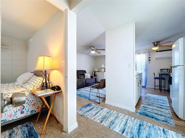 corridor featuring baseboards and a textured ceiling