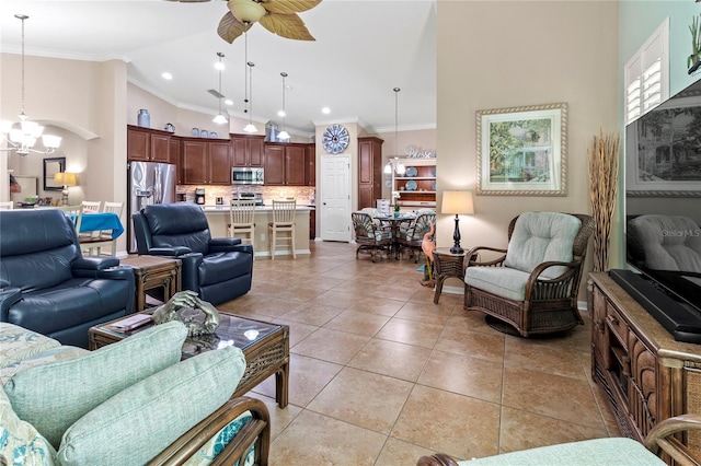 tiled living room featuring ceiling fan with notable chandelier, ornamental molding, and high vaulted ceiling