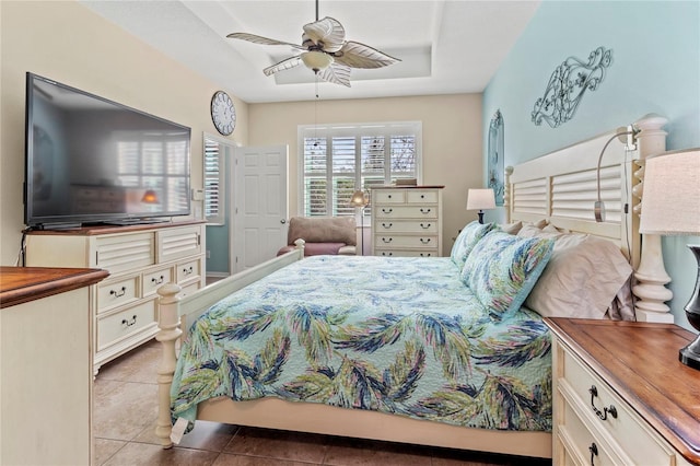 tiled bedroom featuring ceiling fan