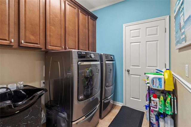 laundry area featuring washer and dryer, light tile patterned floors, sink, cabinets, and crown molding