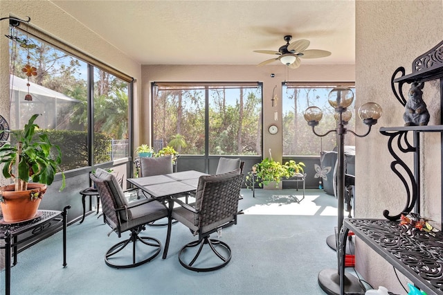 sunroom featuring ceiling fan