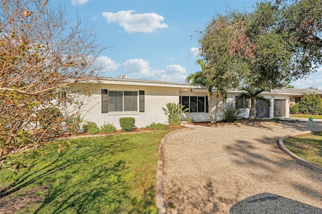 ranch-style house with a garage and a front yard