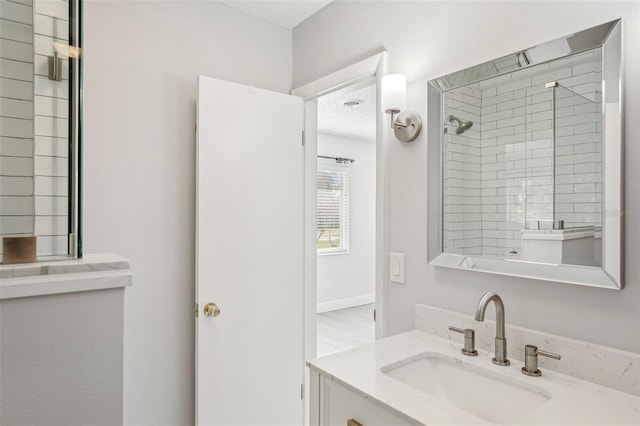 bathroom with vanity and a shower with door