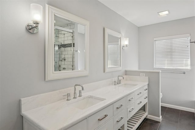 bathroom featuring vanity, tile patterned flooring, and tiled shower