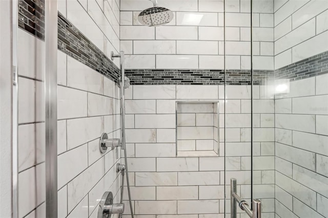 bathroom featuring a shower with shower door