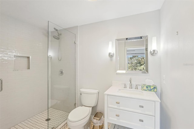 bathroom with vanity, walk in shower, and toilet