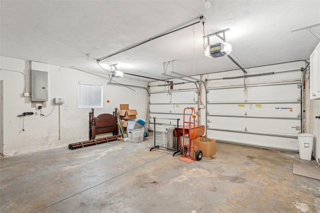 garage with a garage door opener and electric panel