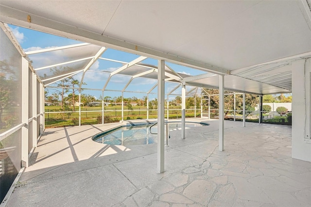 view of pool featuring glass enclosure and a patio area