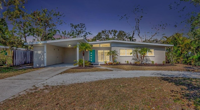 ranch-style home featuring a carport