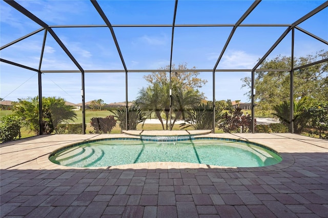 outdoor pool featuring a patio and glass enclosure