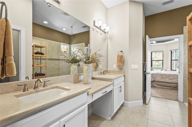 ensuite bathroom with double vanity, visible vents, ensuite bathroom, a sink, and tile patterned floors