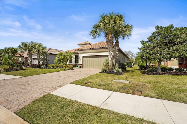 view of front of property with a garage, a tile roof, decorative driveway, stucco siding, and a front yard