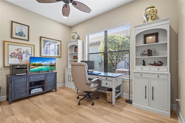 office with baseboards, light wood-style flooring, and a ceiling fan