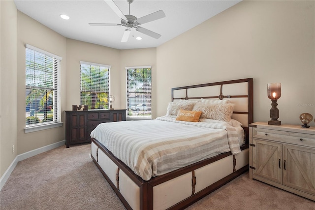 bedroom with baseboards, multiple windows, recessed lighting, and light colored carpet