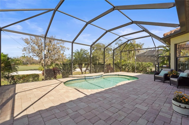 outdoor pool featuring glass enclosure and a patio area