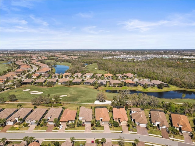 aerial view with a residential view, view of golf course, and a water view