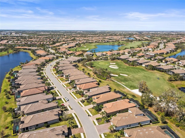 drone / aerial view with a water view and a residential view