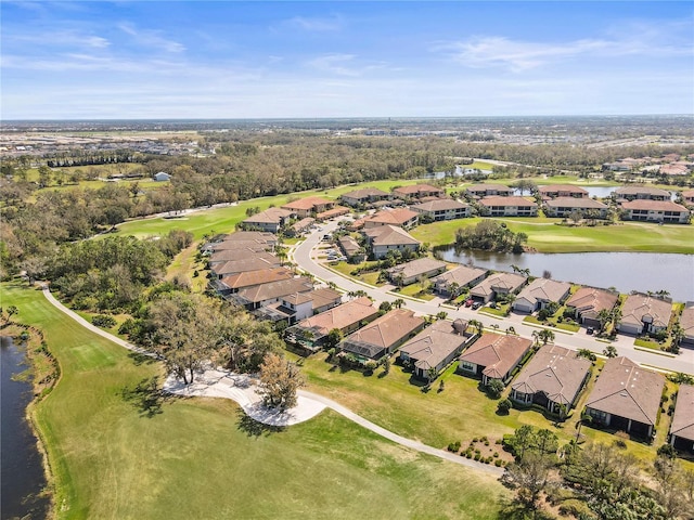 aerial view with a water view, a residential view, and golf course view