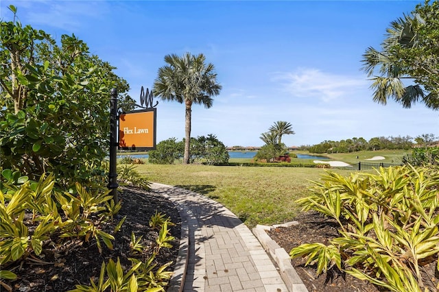 view of community featuring a water view and a lawn