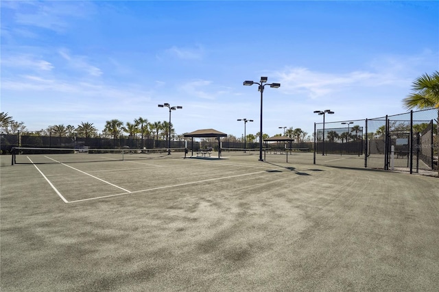 view of tennis court featuring fence