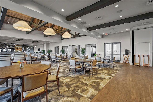 dining area with visible vents, french doors, beamed ceiling, and wood finished floors