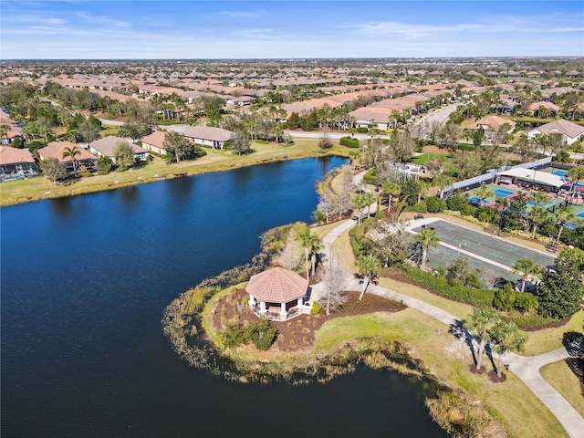 birds eye view of property with a water view and a residential view