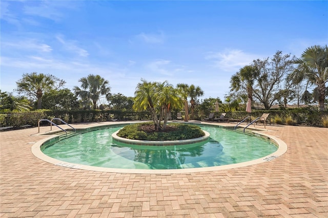 community pool with a patio area