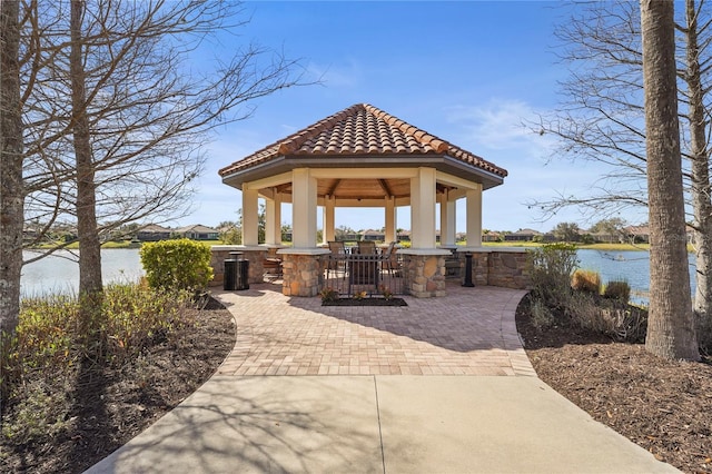 view of patio featuring a water view and a gazebo