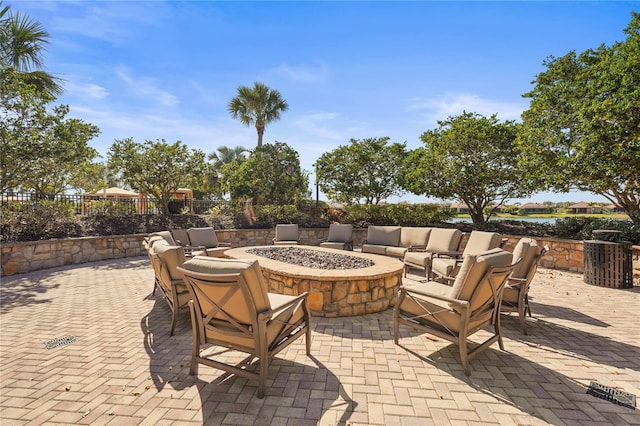 view of patio with a fire pit and fence