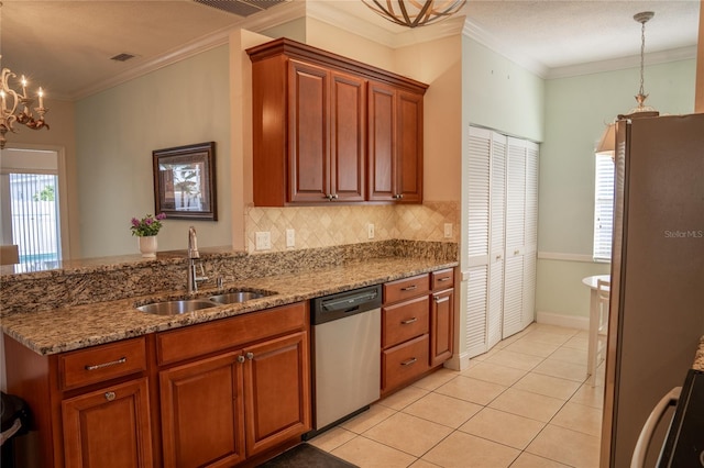 kitchen featuring appliances with stainless steel finishes, a sink, hanging light fixtures, and light tile patterned floors