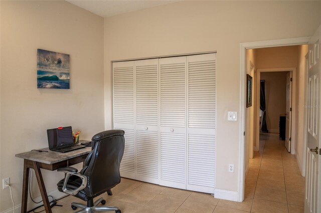 office area with light tile patterned floors and baseboards