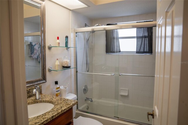 full bath featuring enclosed tub / shower combo, toilet, and vanity