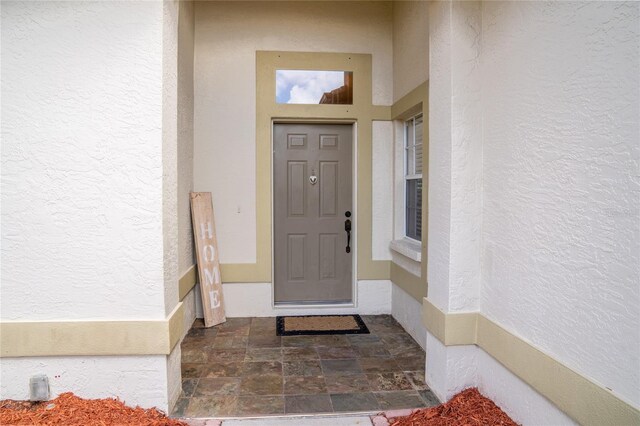 property entrance with stucco siding