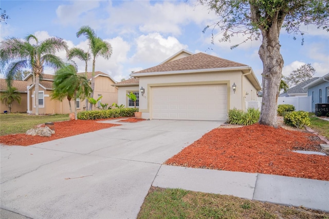 view of front of property with a garage, concrete driveway, and stucco siding