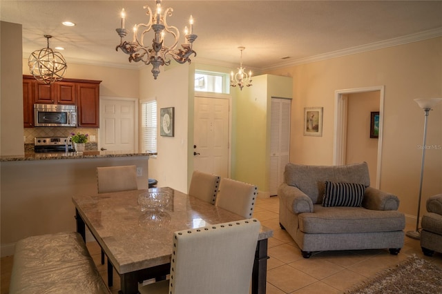 dining area with crown molding, light tile patterned flooring, and a notable chandelier