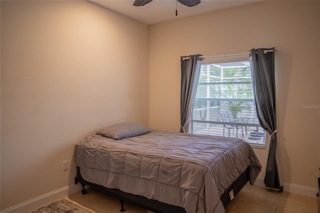 bedroom with light tile patterned floors and baseboards